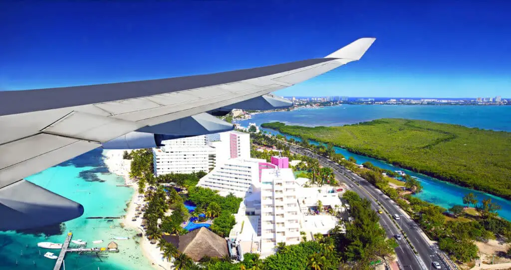 Airplane Flying Over Cancun Hotel Zone: The Best Airport For Tulum